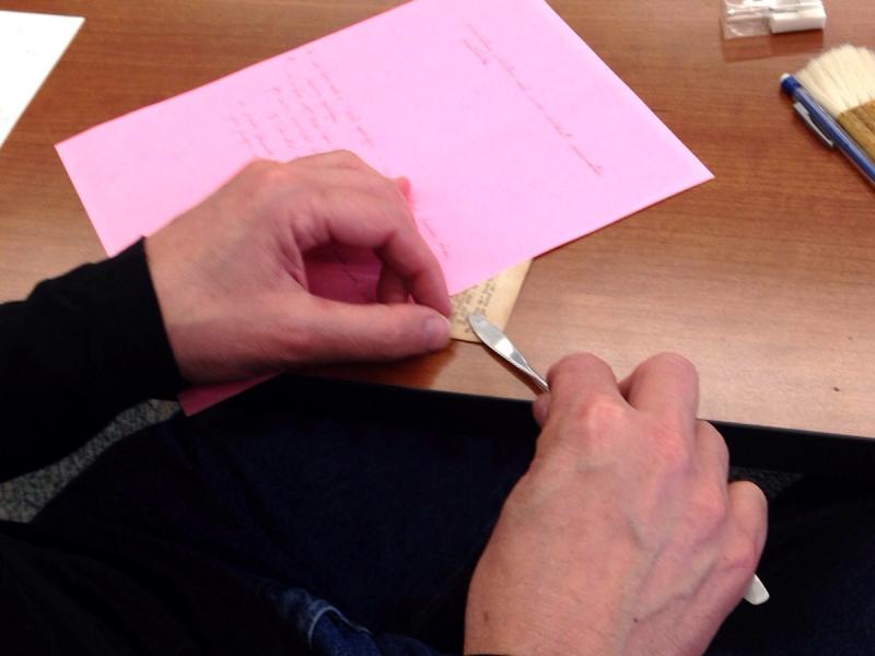 Collections Care workshop image of removing a staple
